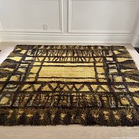 Full overhead view of entire rug showing geometric design and color palette