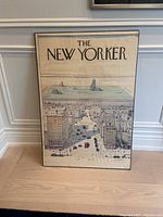 Frontal view of full poster leaning against wall showing entire artwork and frame