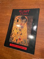 Cover of Taschen Posterbook showing Gustav Klimt's artwork "The Kiss" with title text and branding.