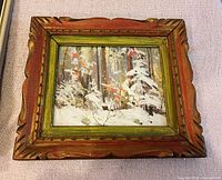 Front view of the painting showing snowy forest scene in carved wood frame