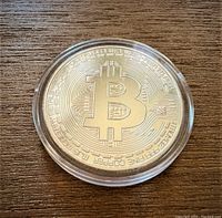 Front view of silver plated Bitcoin coin showing the Bitcoin 'B' logo and detailed circuit background.