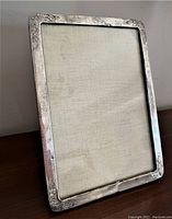 Full view of the rectangular sterling silver picture frame showing its overall condition and surface tarnish.