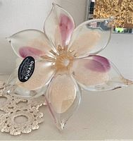 Clear close-up of Murano glass flower showing details of petals and colors.
