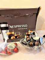 Nespresso Vertuo Plus machine box with capsules in plastic bag and clear container
