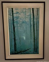 Full view of framed realist painting showing tall trees in a misty wooded scene with black and white frame.