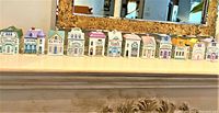 Twelve porcelain cottages in a row showing full set of Spice Village jars.