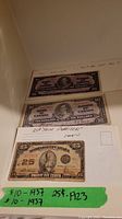 Three banknotes displayed together: two $10 bills and one 25¢ note