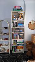 Shelf filled with various boxed puzzles and puzzle storage board.