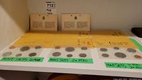 Three sets of 1968, 1970, and 1971 coin sets in original envelopes, each containing five coins displayed.
