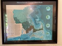 Framed Massachusetts Coastal Watersheds map hung on a wall, showing the full map including coastal and inland watershed details.