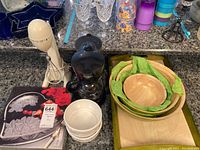 Overview of kitchen appliances and bowls showing Mr.Coffee coffee maker, Hamilton Beach mixer, glass bowls, wood nesting bowls and a serving tray.