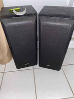 Pair of black Sony SSB 3000 speakers with foam grilles and Sony logo on front, upright position on tiled floor.