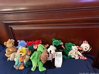 Group photo of 16 Teenie Beanie Babies plush toys, various colors and designs, shown together with some original tags visible.