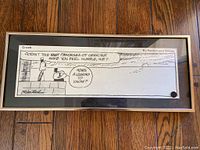 Framed black and white cartoon strip titled 'Crock' showing two characters talking and a scenic background. Signature 'By Rechin and Wilder' visible at top right corner.