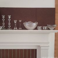 Full set of crystal items on mantle including Mikasa bowl, multiple Villaroy & Boch candle sticks, and smaller floral candle holders.