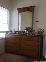 Full front view of oak dresser with attached mirror and items on top