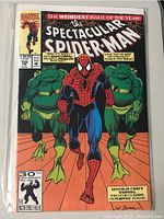 Cover of Marvel Spectacular Spider-Man comic book issue 185 featuring Spider-Man with two frog-like humanoid villains behind him.