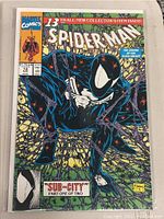 Comic book cover in plastic sleeve featuring Spider-Man in black suit crouching on webbing, issue #13, title 'Sub-City' part one of two, priced $1.75 US.