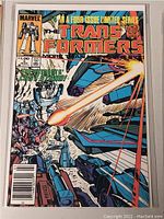Front cover photo of Marvel Transformers comic book issue 4 of 4, colorful vintage cover showing robot characters and an action battle scene with laser beams.
