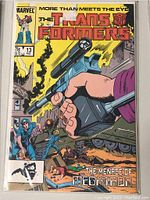 Front cover of The Transformers comic book issue 13 showing detailed illustration with characters and weaponry, along with title and issue information.