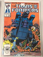 Front cover image of Marvel The Transformers Comic Book Number 27 showing various Transformers characters in action with detailed colored illustrations on orange background.