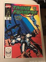 Front cover of Marvel Transformers comic book number 68 titled 'Humans Strike Back'. Colorful graphic showing characters and cityscape, with Marvel Comics and Spider-Man logos.