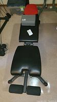 Full top view of the Bowflex workout bench showing black leather padded cushions, foam block with logo, and bench dimensions in seller's description.