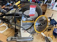 Overall view of Dewalt miter saw showing blade, handle, base, and visible components