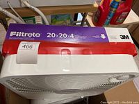 Photo showing boxed Filtrete 20x20x4 inch air filter on top of a white box fan
