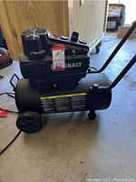 Side view of black Kobalt portable compressor with wheels and handle