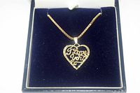 Necklace and heart pendant displayed in open blue jewelry case