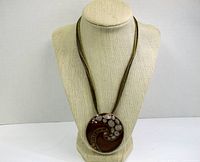 Full view of the necklace displayed on a bust showing the entire necklace and pendant shape