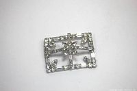 Photo of rectangular clear rhinestone brooch with geometric frame and starburst cluster center.