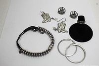 Full lot with bracelet, earrings, and ring displayed including the black ring holder