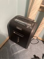 Front angled view of the black Fellowes 79Ci paper shredder showcasing the top slot and control panel.