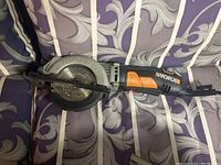 Side view of WorxSaw circular saw showing blade and guard.