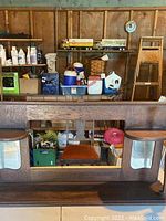 Full view of wooden fireplace mantle with attached mirrors showing all three mirrors and wood grain