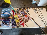Table with assorted flags, garden decor including garden spinner and candle