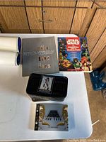 Top view of the Star Wars collectibles set including books, black box with metal cards, and postcards set.