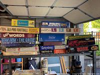 Photo shows a large stack of vintage board games including Yahtzee, Jeopardy!, The Game of Life, Trivial Pursuit, Risk, Dungeons & Dragons, Chinese Checkers, and others.