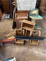 Overall view of wooden miniature chairs, assorted wooden shelves, and folding metal corner shelf.