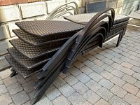 Stack of five chairs showing frames and wicker surfaces