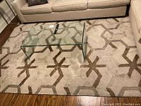 Full view of carpet under glass coffee table against sofa