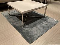 Full view under coffee table showing entire rug and scale