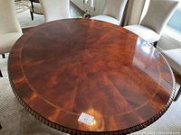 Overhead view of oval flamed mahogany tabletop showing veneer pattern and rope-twist inlay