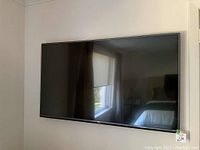 Front view of wall-mounted 55-inch LG Ultra HD TV.