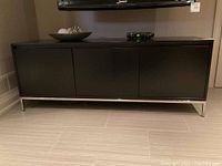 Front view of console under mounted TV