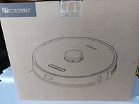 Closed cardboard box with Proscenic branding and line drawing of robot vacuum