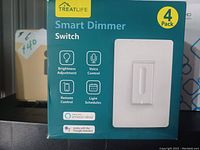 Front of packaging for Treatlife Smart Dimmer Switch 4-pack showing brand, product features like brightness adjustment, voice control, remote control, light schedules, compatibility with Amazon Alexa and Google Assistant.