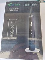 Front view of Safcare Sonic Electric Toothbrush box showing model SC-201 and features such as IPX7 water resistance, smart timer, 50 days battery life.